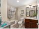 Bathroom with a tub-shower combo, cherry vanity, and stylish fixtures for a relaxing experience at 832 Parrish Pl, The Villages, FL 32163