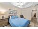 Comfortable bedroom with a ceiling fan, dresser, and large closet providing ample space and storage at 832 Parrish Pl, The Villages, FL 32163
