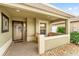 Cozy covered front porch featuring decorative accents, seating and a beautifully designed doorway at 832 Parrish Pl, The Villages, FL 32163