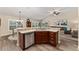 Open concept kitchen with stainless steel appliances, breakfast bar, and seamless flow to the living area at 832 Parrish Pl, The Villages, FL 32163