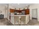 Well-appointed kitchen features stainless steel appliances, wood cabinets, and a convenient breakfast bar with seating at 832 Parrish Pl, The Villages, FL 32163