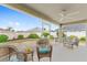 Screened lanai with wicker furniture, ceiling fan, and scenic backyard view creating an inviting outdoor space at 832 Parrish Pl, The Villages, FL 32163
