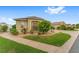 Beautifully landscaped corner lot with lush green grass and meticulously arranged plants and shrubbery at 832 Parrish Pl, The Villages, FL 32163