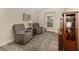 Comfortable living room with cozy chairs, side table, and window for relaxation and natural light at 832 Parrish Pl, The Villages, FL 32163