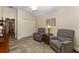 Living room with seating area, ceiling fan, and closet doors for a blend of comfort and functionality at 832 Parrish Pl, The Villages, FL 32163