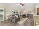 Inviting living room with stylish furnishings, a console table, and an open view of the kitchen area at 832 Parrish Pl, The Villages, FL 32163
