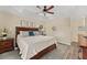 The main bedroom features a tray ceiling, a large bed, and soft lighting, creating a relaxing retreat at 832 Parrish Pl, The Villages, FL 32163