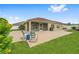 Large patio area with seating, perfect for enjoying the outdoors, plus grill and screened-in porch at 832 Parrish Pl, The Villages, FL 32163