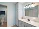 Clean bathroom with a white vanity, mirror, storage, and a toilet at 8639 Se 141St Pl, Summerfield, FL 34491
