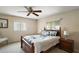 Cozy bedroom featuring a ceiling fan, and a large, comfortable bed at 8639 Se 141St Pl, Summerfield, FL 34491