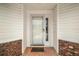 Inviting front entrance with white door, sidelight window, and brick accents at 8639 Se 141St Pl, Summerfield, FL 34491