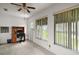 Bright home office space with large windows, a ceiling fan, and neutral carpeting at 8639 Se 141St Pl, Summerfield, FL 34491