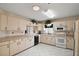 Bright kitchen features tile flooring, lots of counter space, plus neutral-colored cabinets at 8639 Se 141St Pl, Summerfield, FL 34491