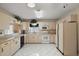 Spacious kitchen with white appliances, tile backsplash, and ample cabinetry for storage solutions at 8639 Se 141St Pl, Summerfield, FL 34491