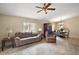 Comfortable living room space with tile flooring and a ceiling fan at 8639 Se 141St Pl, Summerfield, FL 34491