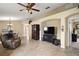 Spacious living room with tile flooring, ceiling fan, and open archways at 8639 Se 141St Pl, Summerfield, FL 34491