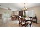 Bright living room with tile flooring, ceiling fan, and sliding glass doors at 8639 Se 141St Pl, Summerfield, FL 34491