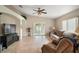 Cozy living room featuring tile flooring, a ceiling fan, and comfortable seating at 8639 Se 141St Pl, Summerfield, FL 34491