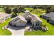 Aerial view of a beautiful home with a well-kept lawn and lush landscaping at 9059 Se 177Th Grassmere St, The Villages, FL 32162