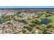 Aerial shot showcasing a home in a neighborhood with a golf course and ponds at 9059 Se 177Th Grassmere St, The Villages, FL 32162