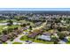Aerial view of home in a community near a golf course and lake at 9059 Se 177Th Grassmere St, The Villages, FL 32162