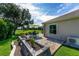 Beautiful outdoor space with a stone patio, golf course view, and manicured lawn at 9059 Se 177Th Grassmere St, The Villages, FL 32162