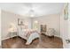 Cozy bedroom featuring a ceiling fan, hardwood floors, and a bright window at 9059 Se 177Th Grassmere St, The Villages, FL 32162