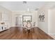Bright dining room featuring wood floors, decorative mirror and circular table with seating for four at 9059 Se 177Th Grassmere St, The Villages, FL 32162