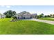 Spacious home with a three-car garage and a beautifully landscaped front yard at 9059 Se 177Th Grassmere St, The Villages, FL 32162