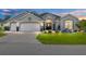 Charming single-story home with a well-manicured lawn and paved driveway at 9059 Se 177Th Grassmere St, The Villages, FL 32162