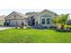 Well-maintained front yard with lush green grass and a charming water feature at 9059 Se 177Th Grassmere St, The Villages, FL 32162