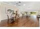Open-concept living space featuring wood floors, a ceiling fan, and sliding glass doors leading to the outdoors at 9059 Se 177Th Grassmere St, The Villages, FL 32162