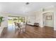 Spacious living room features hard wood floors, vaulted ceilings, and screened patio overlooking golf course at 9059 Se 177Th Grassmere St, The Villages, FL 32162