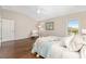 Comfortable bedroom with hardwood floors, natural light, and neutral tones for a relaxing retreat at 9059 Se 177Th Grassmere St, The Villages, FL 32162