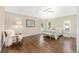 Spacious bedroom features hardwood floors, natural light, and a seating area at 9059 Se 177Th Grassmere St, The Villages, FL 32162