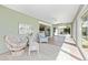 Cozy sun room featuring comfortable seating, neutral decor, and ample natural light at 9059 Se 177Th Grassmere St, The Villages, FL 32162