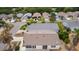 Showing the community street, the house's roof, trees and the home's location at 9321 Se 172Nd Augusta Ln, The Villages, FL 32162