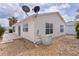 Rear exterior view showcasing the home's AC unit, well-maintained siding, and landscaping at 9321 Se 172Nd Augusta Ln, The Villages, FL 32162