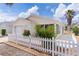 Single-story home featuring a manicured lawn, white picket fence, and a well-kept facade at 9321 Se 172Nd Augusta Ln, The Villages, FL 32162