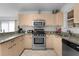 Bright kitchen with stainless steel appliances, granite countertops, and light wood cabinets at 9321 Se 172Nd Augusta Ln, The Villages, FL 32162