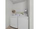 Laundry room features a new white washer and dryer at 9321 Se 172Nd Augusta Ln, The Villages, FL 32162