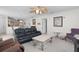 Cozy living room features a ceiling fan, comfortable seating, and an open floor plan leading to the kitchen at 9321 Se 172Nd Augusta Ln, The Villages, FL 32162
