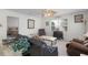 Comfortable living room with a ceiling fan, neutral decor, and view to the hallway and bedroom at 9321 Se 172Nd Augusta Ln, The Villages, FL 32162