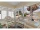Bright sunroom featuring wicker furniture and a view to the neighborhood at 9321 Se 172Nd Augusta Ln, The Villages, FL 32162