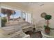 Enclosed sunroom featuring wicker seating, tile flooring, and views of the yard at 9321 Se 172Nd Augusta Ln, The Villages, FL 32162