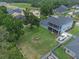 Aerial view of spacious backyard, covered patio, fire pit, boat storage, and well-maintained lawn at 9512 Mid Summer Ln, Leesburg, FL 34788