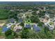 Aerial view of property in a lush, green neighborhood, showcasing its location and surrounding homes at 9512 Mid Summer Ln, Leesburg, FL 34788