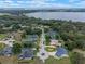 Beautiful aerial view of a lakeside community featuring large homes, mature trees, and stunning water views at 9512 Mid Summer Ln, Leesburg, FL 34788