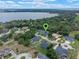 Aerial view of property surrounded by lush landscapes and a beautiful lake nearby, offering serene living at 9512 Mid Summer Ln, Leesburg, FL 34788