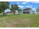 Large backyard features a playset, seating, and mature trees offering plenty of space for outdoor activities at 9512 Mid Summer Ln, Leesburg, FL 34788